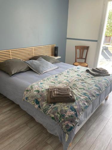 - un lit avec une couverture et un porte-monnaie dans l'établissement Villa les hortensias, à Vaucelles