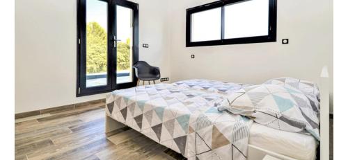 une chambre avec un lit et deux fenêtres dans l'établissement Jolie villa avec piscine sans vis a vis, à Bezouce