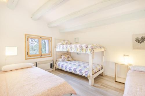 a bedroom with two beds and a bunk bed at Can Favo in Copóns