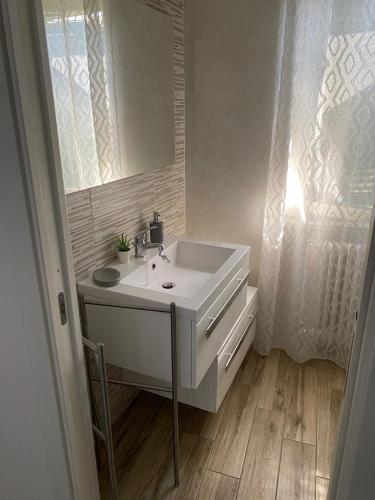 a bathroom with a white sink and a mirror at La mia Marì in Palestrina