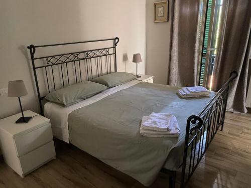 a bedroom with a large bed with two towels on it at La mia Marì in Palestrina