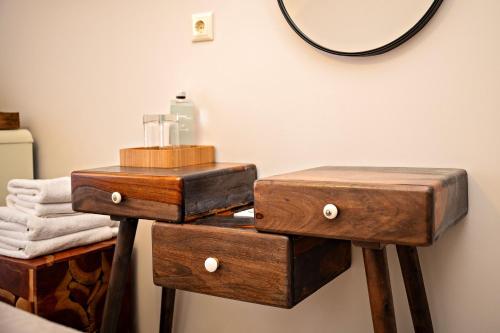 a pair of nightstands with wooden boxes and a mirror at Avra in Parga