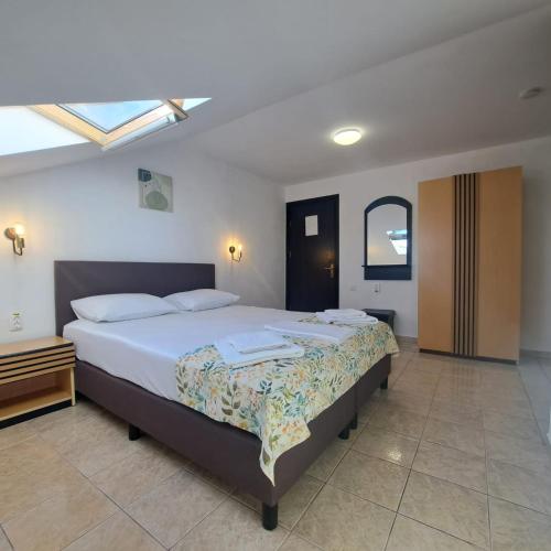 a bedroom with a large bed in a room at VILA TAMI in Costinesti