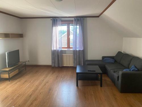 a living room with a couch and a table at Vetlandavägen 37b 1102 in Målilla