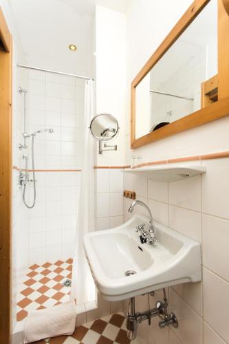 a bathroom with a sink and a mirror at Hotel-Gasthof Weitgasser in Mauterndorf