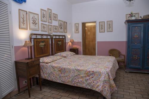 a bedroom with a bed and a dresser and a table at La Limonaia a mare in Ponza