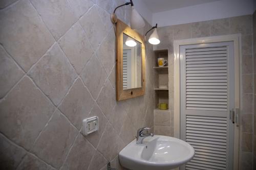 a bathroom with a sink and a mirror at La Limonaia a mare in Ponza