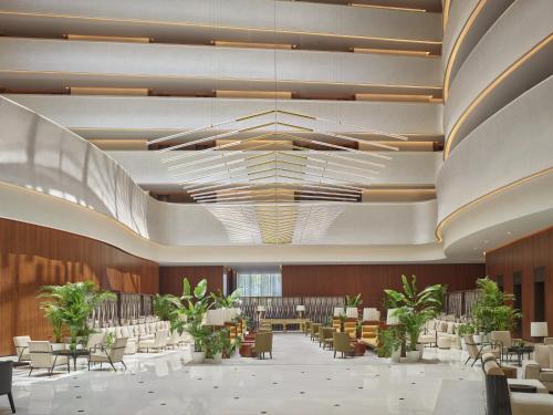 a rendering of a lobby with chairs and tables at The Abu Dhabi EDITION in Abu Dhabi