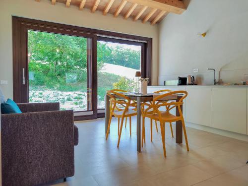 a dining room with a table and chairs in a kitchen at La Fonte Delle Faranghe by Host Hero in Esanatoglia