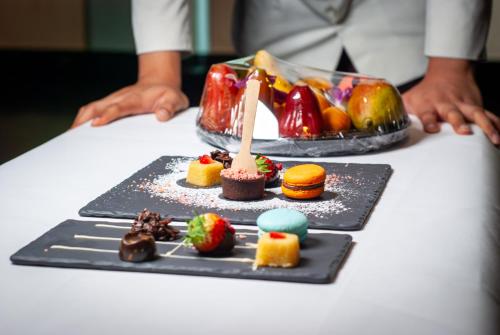 a table with a plate of desserts on a table at Tower Club at lebua in Bangkok