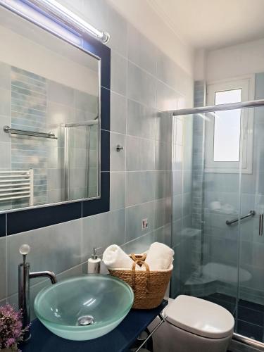 a bathroom with a sink and a toilet and a shower at ARIA Luxury Apartments in Nafplio