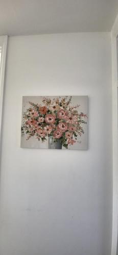 a picture of a vase of flowers on a wall at Delight Home-London City Airport & Excel in London