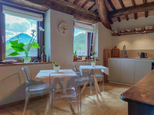 a kitchen and dining room with tables and chairs at La Fonte Delle Faranghe by Host Hero in Esanatoglia