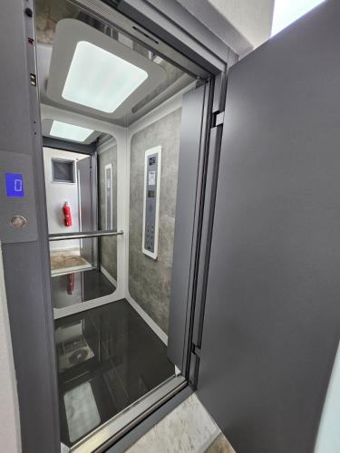 a small room with a walk in shower with a glass door at Casa Di Estella in Neos Marmaras