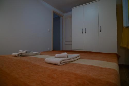 a bedroom with a large bed with towels on it at Apartman Marko Cres in Cres