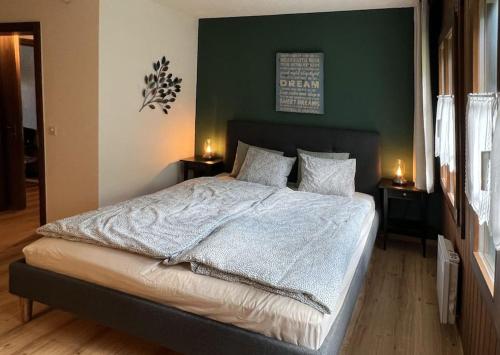 una camera da letto con un grande letto con due comodini di Chalet Oasis - Your Alpine Hideaway a Bürglen