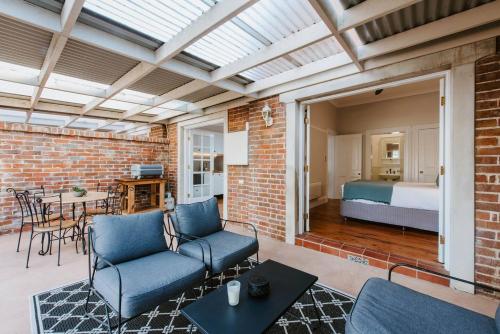 una sala de estar con un sofá y una cama en Kialla Cottage - An Idyllic Country Escape, en Mudgee