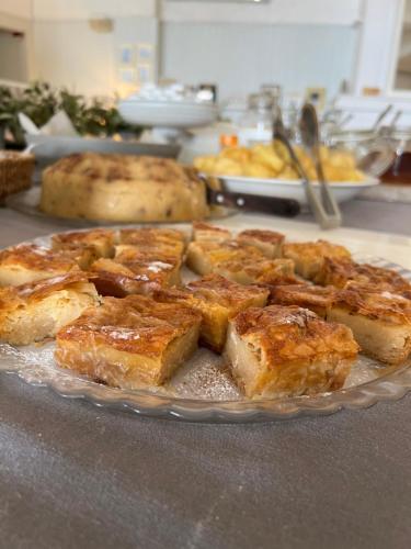 a plate of food on a counter with bread at Paradisos in Áyioi Pándes