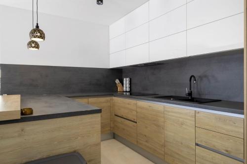 a kitchen with white cabinets and a sink at Villa Petrina in Sveti Petar u Šumi