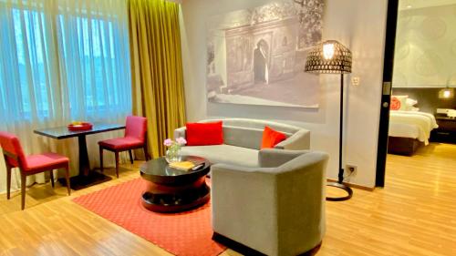 a living room with a couch and a table at Vivanta Guwahati in Guwahati
