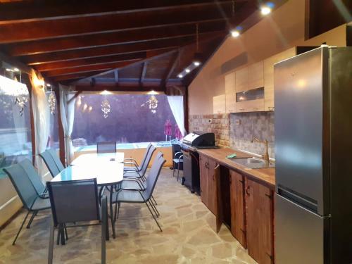 a kitchen with a table and chairs and a refrigerator at Sokol i Kalina spa in Pchelin
