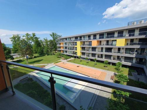 a balcony of a building with a swimming pool at Casa Romana Aqua Apartman in Siófok