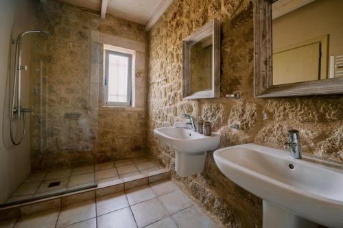 a bathroom with two sinks and a mirror at Riglia Villas in Riglia