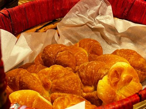 a basket full of croissants and orange slices at Imperial Hotel Kuching in Kuching
