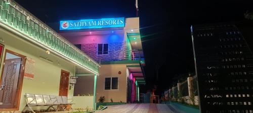 a building with a sign that reads malcolm kennlords at Sathyam Resorts in Dharmapuri