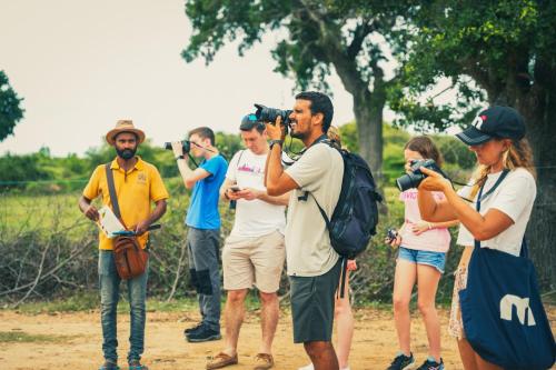 a group of people taking pictures with cameras at Yakaduru - Yala in Yala