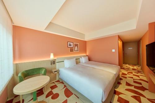a hotel room with a bed and a table and chair at The Royal Park Hotel Ginza 6-Chome in Tokyo