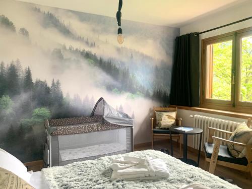 a bedroom with a mountain mural on the wall at Chalet Le Tilleul in Valdeblore