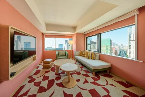 a living room with a couch and a table at The Royal Park Hotel Ginza 6-Chome in Tokyo