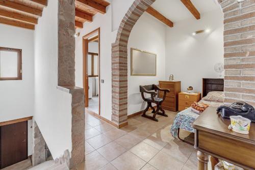 a living room with a bed and a desk in a room at Casa rustica in Gonnesa
