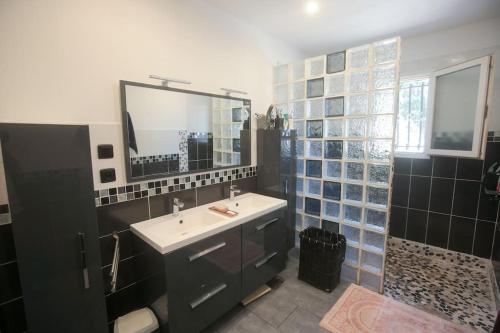 a bathroom with a sink and a mirror at Maison 4 chambres avec piscine in Saint-Gilles