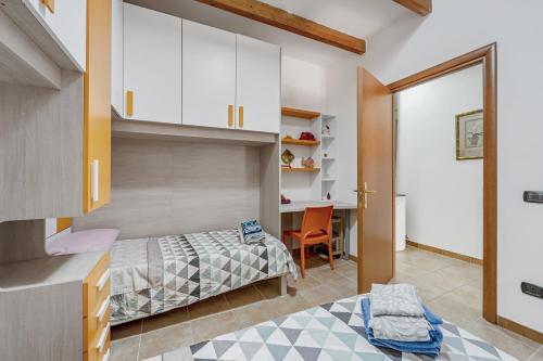 a bedroom with a bed and a desk in a room at Casa rustica in Gonnesa