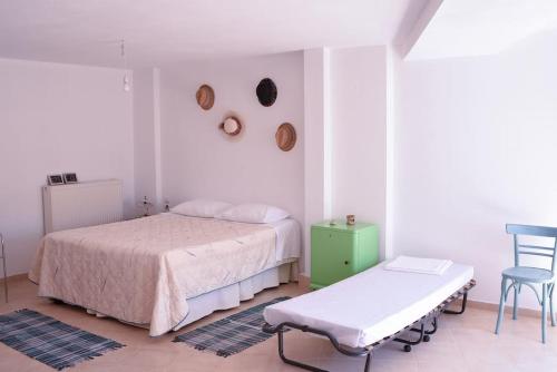 a bedroom with a bed and a table and a chair at thalassa home in Nikiana