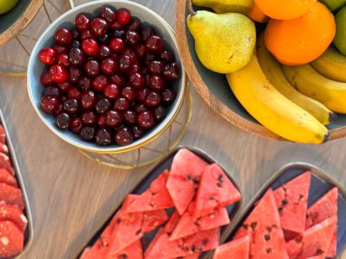 a table topped with bowls of fruits and vegetables at SeeSea Hotel in Vodice