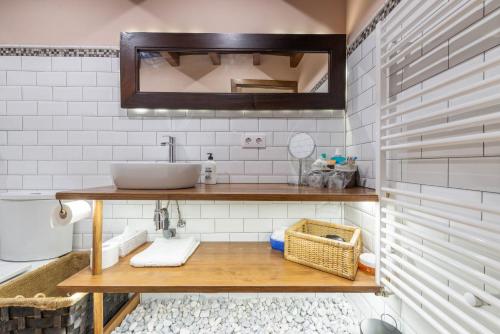 a bathroom with a sink and a mirror at Casa Rural Herencia de Ganaderos "Sierra de Gredos- Ávila" in San Martín de la Vega del Alberche