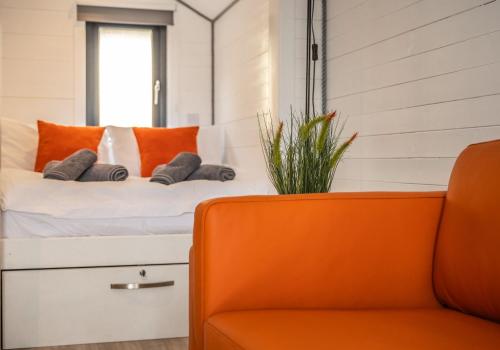 a bedroom with a bed and an orange chair at Nessie Pod in Fort Augustus