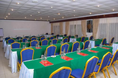 a conference room with green and blue tables and chairs at Cocoa Luxury Resort, Nyali, Mombasa in Mombasa