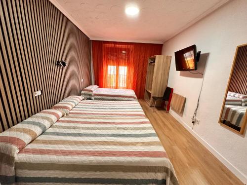 Postel nebo postele na pokoji v ubytování Hostal Rober