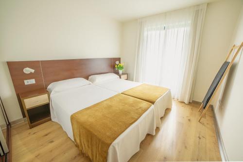 Katil atau katil-katil dalam bilik di Apartamentos Dunas de Liencres