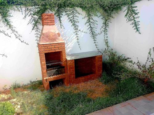a brick oven sitting on the side of a building at Villa de luxe avec piscine sans vis à vis Midoun in Aghīr