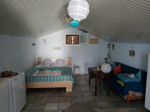 a small bedroom with a bed and a table at Amfialos in Skala Kallirakhis