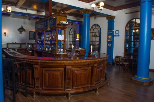 a bar in a room with blue columns at Cocoa Luxury Resort, Nyali, Mombasa in Mombasa
