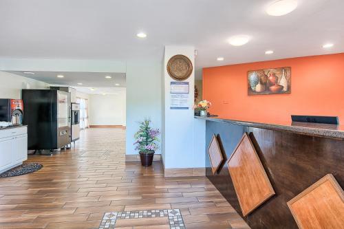 a lobby of a hospital with an orange wall at Motel 6-Harrisonburg, VA - South in Harrisonburg