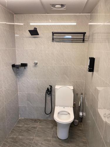 a bathroom with a toilet and a shower at House of Healing Homestay in Kampong Sura Tengah