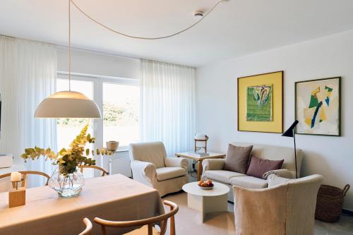 a living room with a couch and a table at Vier Häuser in Norderney
