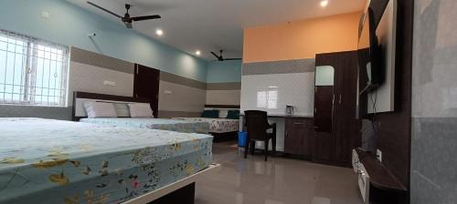 a bedroom with two beds and a kitchen in it at Sathyam Resorts in Dharmapuri